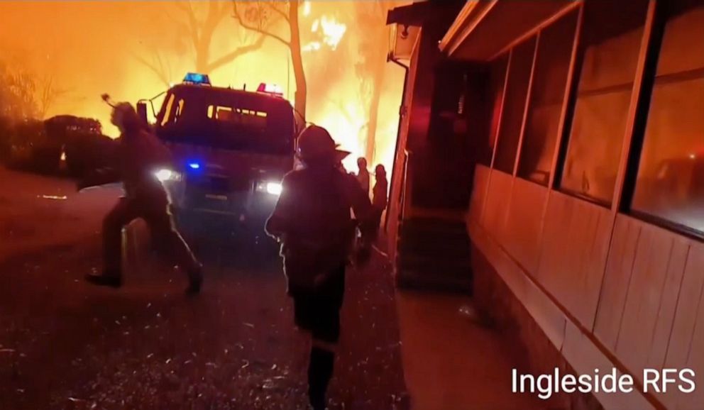PHOTO: This image made from video taken on Dec. 22, 2019, and provided Dec. 25, 2019, by Ingleside Rural Fire Brigade, shows the wildfire behind an emergency vehicle near property on Hat Hill Road in Blackheath, New South Wales.