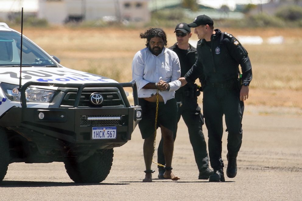PHOTO: Terence Darrell Kelly boards a plane after being taken into custody by members of the Special Operations Group at Carnarvon airport, Nov. 5, 2021, in Carnarvon, Australia.