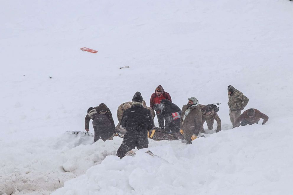 PHOTO:Security officers and villagers carry a victim of an avalanche near the town of Bahcesehir, in the eastern Turkey province of Van, Feb. 5, 2020,