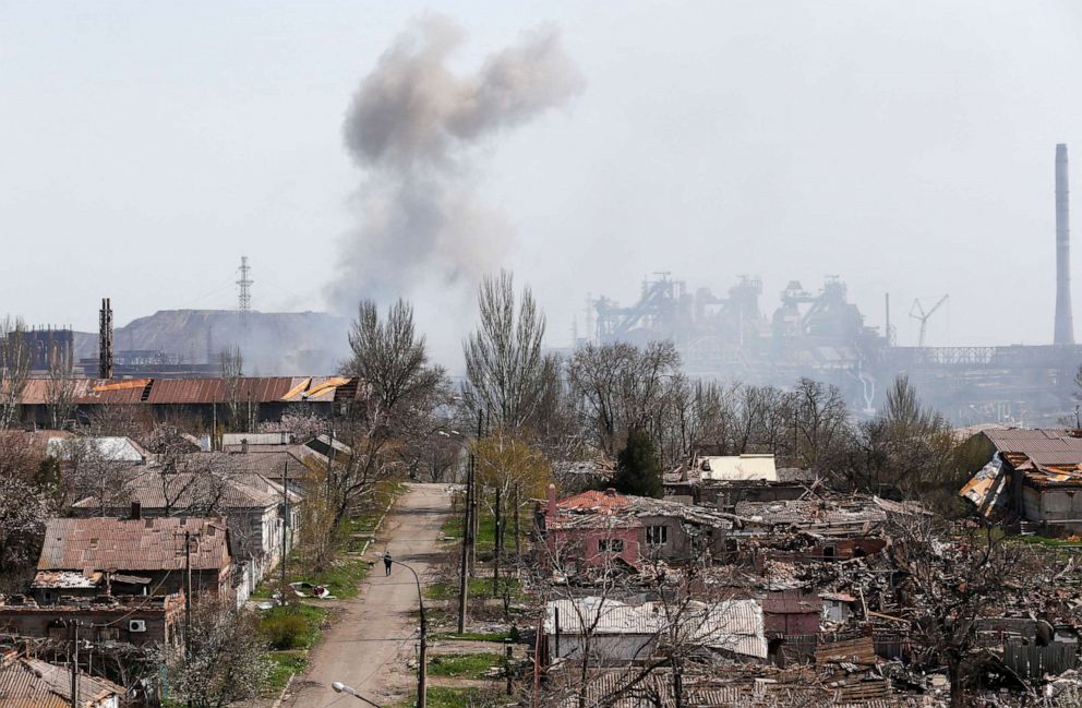 PHOTO: Smoke rises above a plant of Azovstal Iron and Steel Works company and buildings damaged in the southeastern port city of Mariupol, Ukraine, on April 18, 2022, amid Russia's invasion.