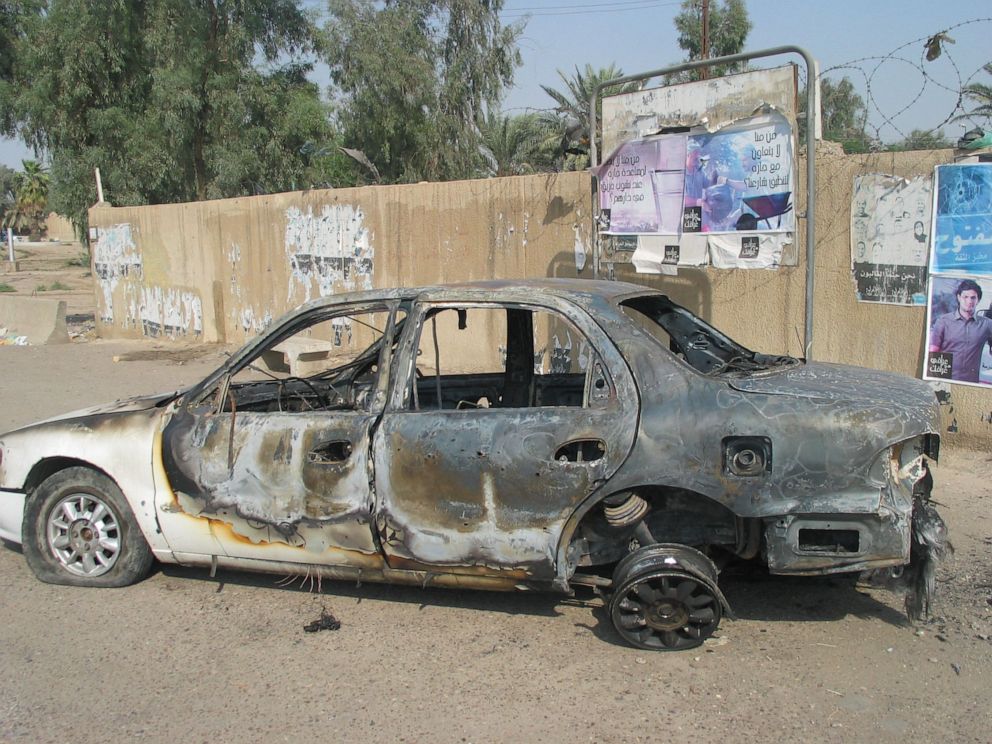 PHOTO: A burned-out car sits at a traffic circle in central Baghdad on Sept. 17, 2007, where a shoot-out with private security company Blackwater left 9 Iraqis dead and 15 injured.