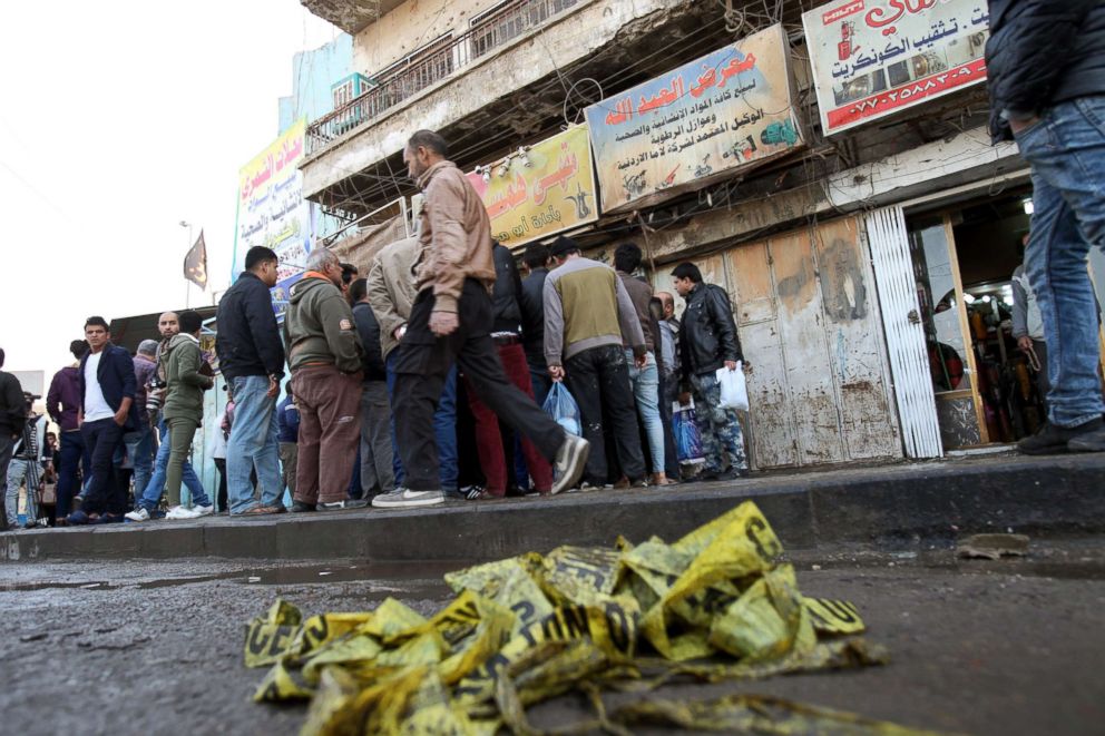 PHOTO: Local residents gather at the scene of double suicide bomb attack at Tayaran square, in central Baghdad, Iraq, Jan. 15, 2018. 