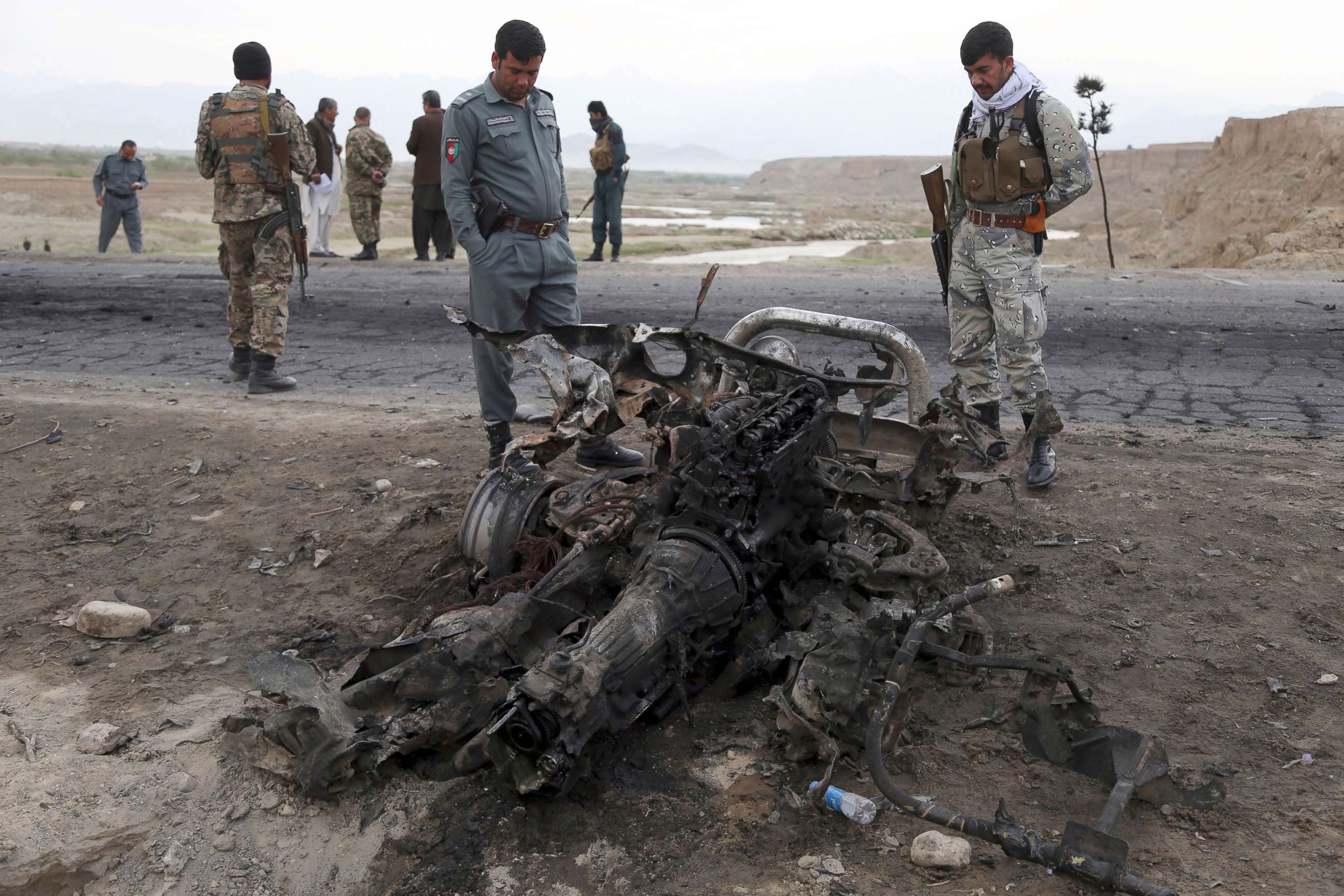 PHOTO: Afghan security forces gather at the site of Monday's suicide attack that killed three american service members near the Bagram Air Base, north of Kabul, Afghanistan, April 9, 2019.