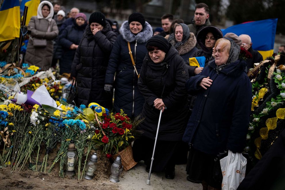 PHOTO: Maria, 70, second right, mourns during the funeral of her son Ruslan Zastavnyi, in Lviv cemetery, Ukraine, on Feb. 20, 2023. Zastavnyi joined the army in March 2022, died two weeks ago near Bakhmut.