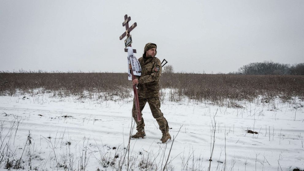 PHOTO: Oleksiy Storozh, 28, carries a cross i n Sloviansk, on Jan. 30, 2023, to be placed at the grave of his late best friend, Oleksandr Korovniy, 28, a Ukrainian serviceman of the Azov battalion killed in action in Bakhmut.