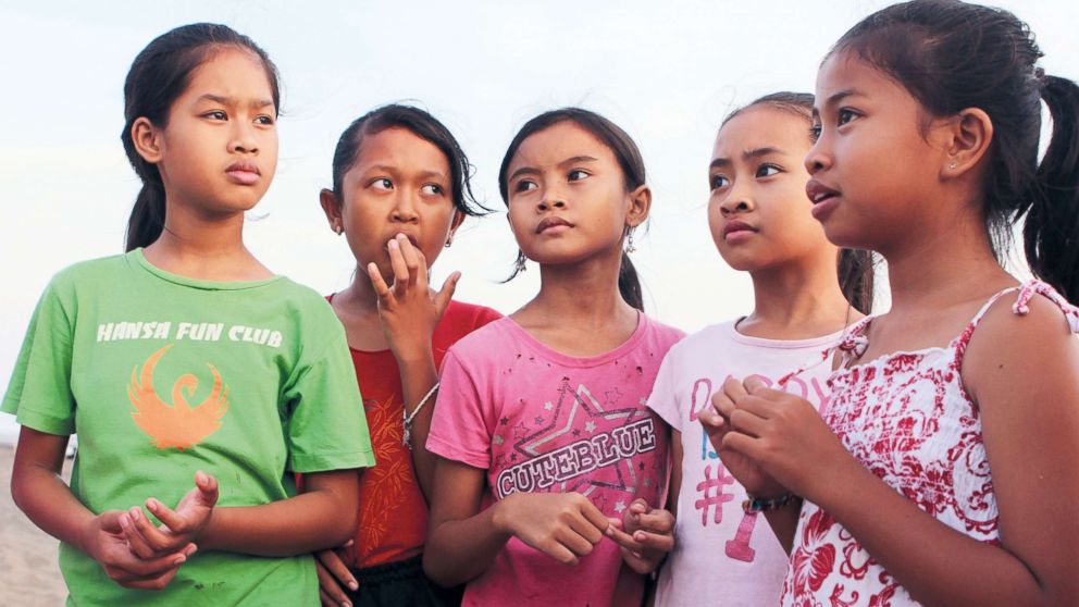 Balinese children are convincing tourists and locals to stop using plastic bags, which are destroying their idyllic island environment, Bali, Indonesia.