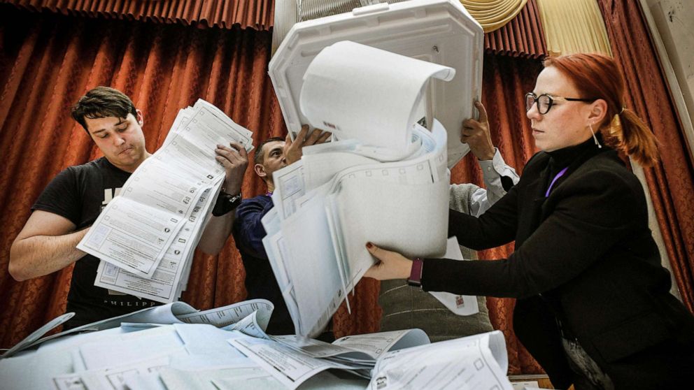 PHOTO: Members of a local electoral commission empty a ballot box at a polling station after the last day of the three-day parliamentary election, in Moscow, Sept. 19, 2021.
