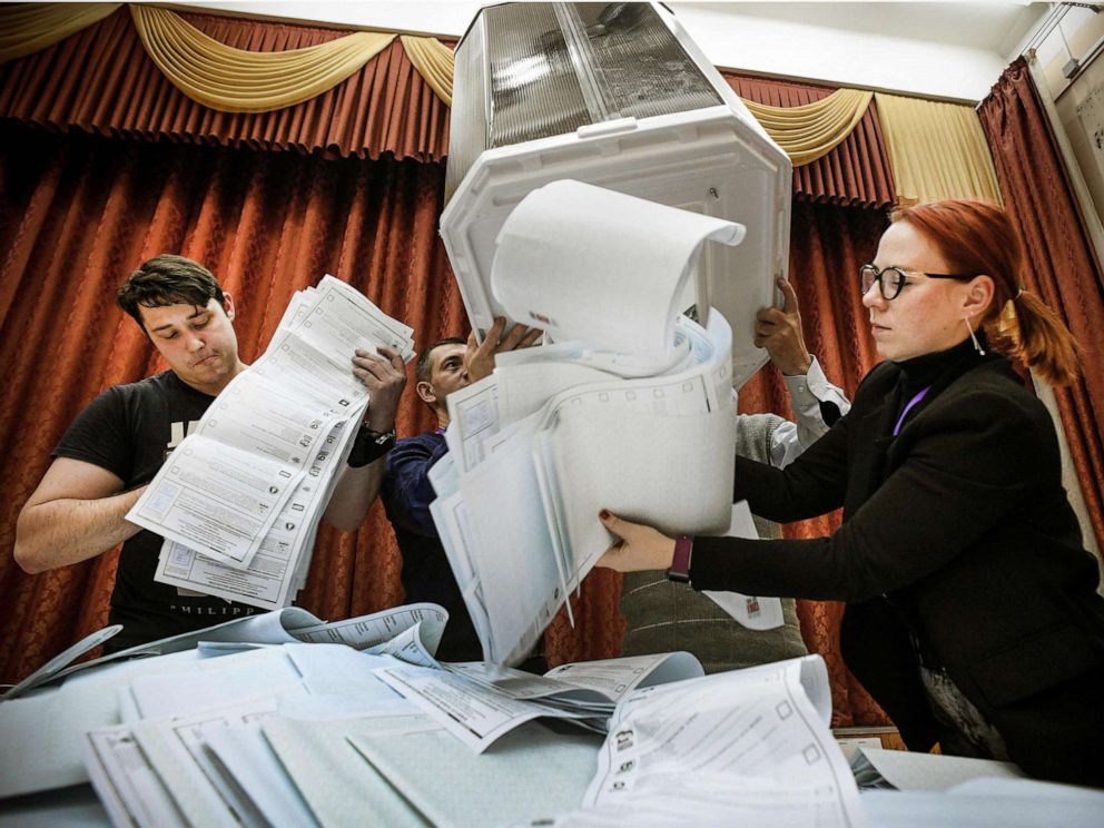 PHOTO: Members of a local electoral commission empty a ballot box at a polling station after the last day of the three-day parliamentary election, in Moscow, Sept. 19, 2021.