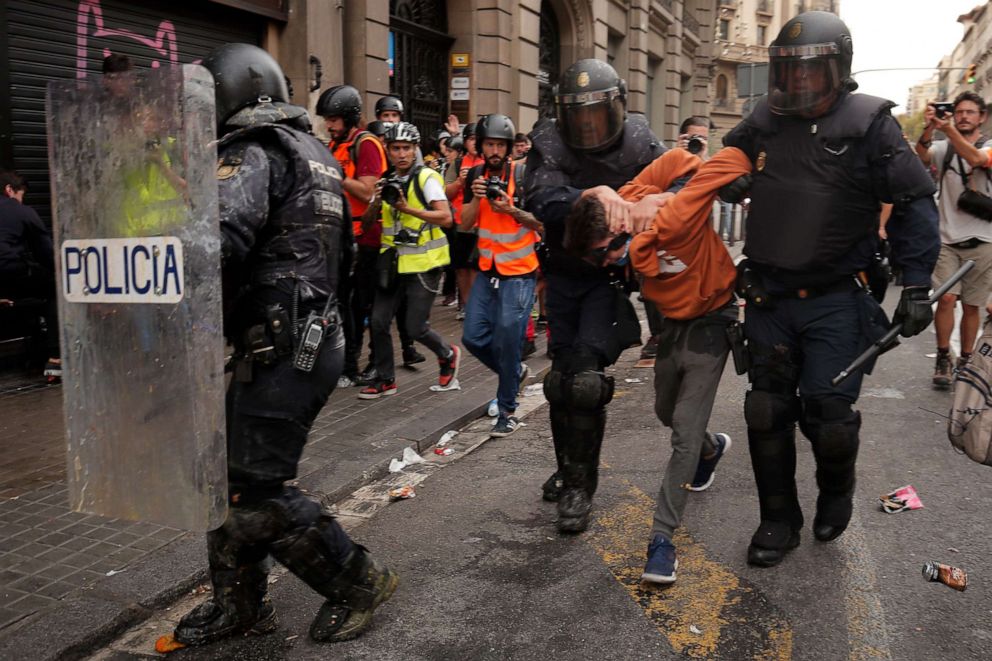 PHOTO: Police officers arrest a protester during a demonstration called by students, on October 18, 2019, on the day that separatists have called a general strike and a mass rally.