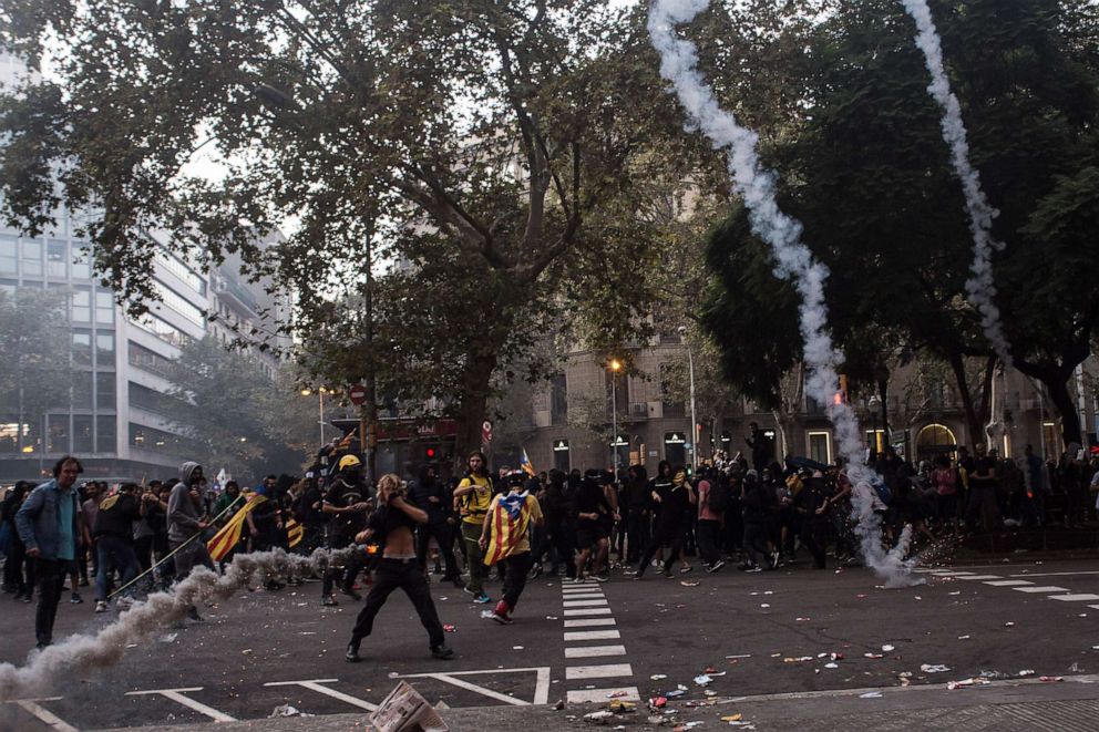 PHOTO: The police throw tear gas to the protesters, in Barcelona, Spain, on October 18, 2019.