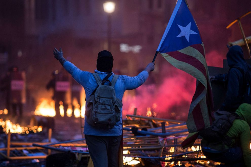 PHOTO: On all the barricades they wave flags. Protester with the Catalan independence flag, Estelada, in Barcelona, Spain, on October 18, 2019.