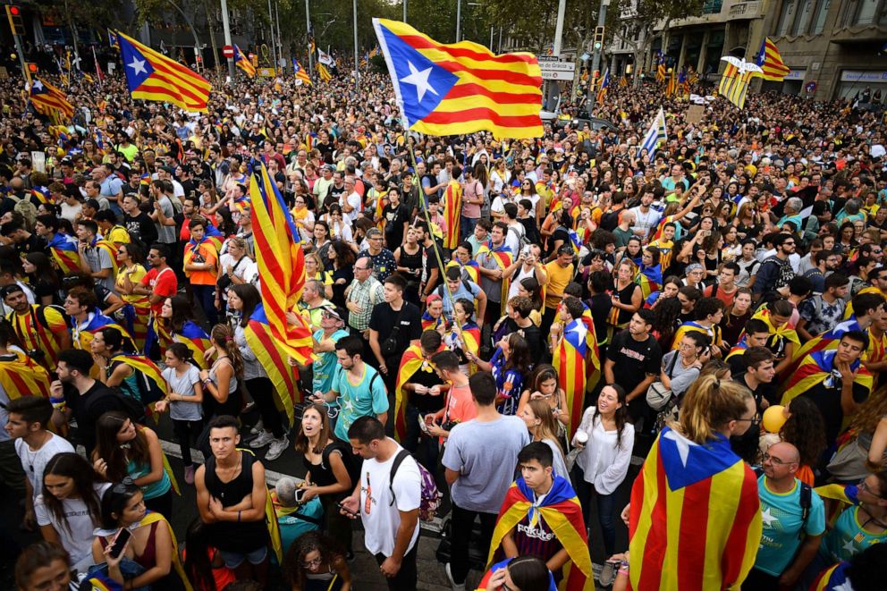 PHOTO: Protesters wave flags in the street as a general strike is called following a week of protests over the jail sentences given to separatist politicians by Spain's Supreme Court, on October 18, 2019 in Barcelona, Spain.