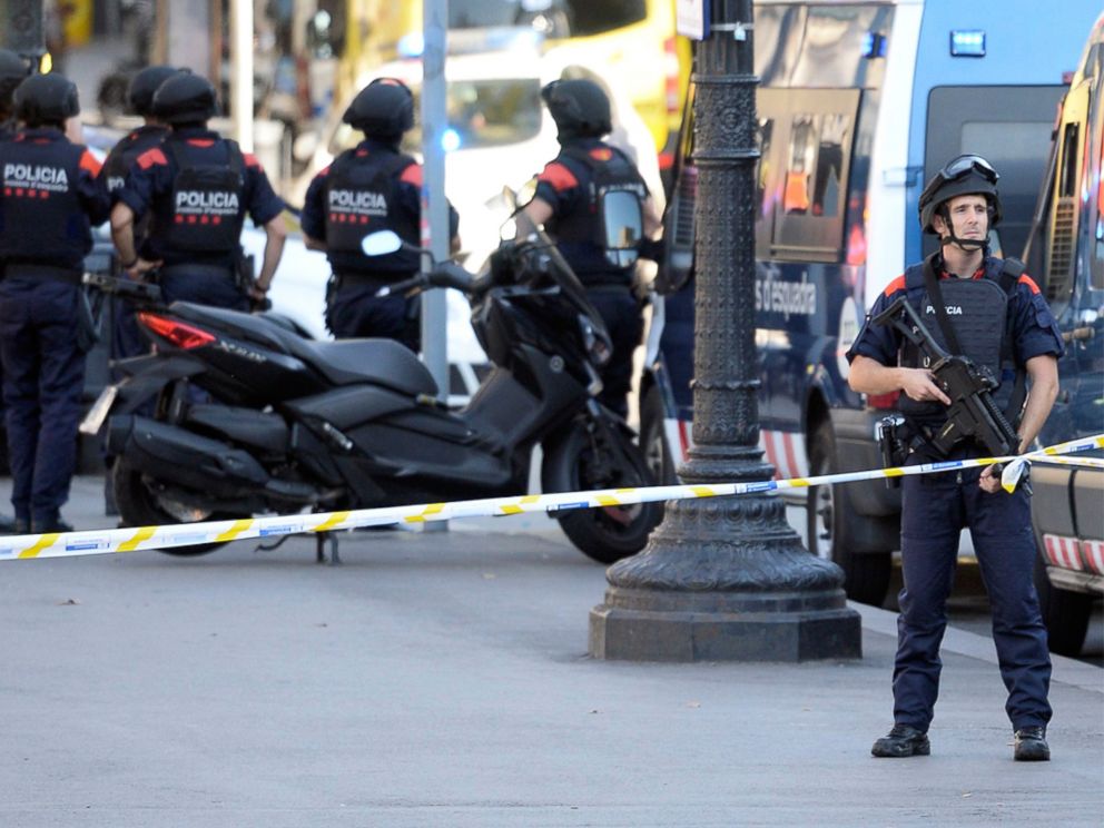 PHOTO: Armed policemen stand in a cordoned off area after a van plowed into a crowd on the city's famous Las Ramblas boulevard, in Barcelona, Aug. 17, 2017.