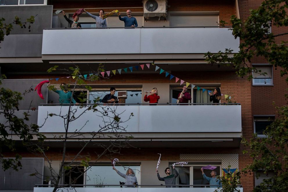 PHOTO: People play instruments as others dance on their balconies in support of the medical staff that are working on the frontlines of the novel coronavirus outbreak, in Barcelona, Spain, on April 5, 2020.