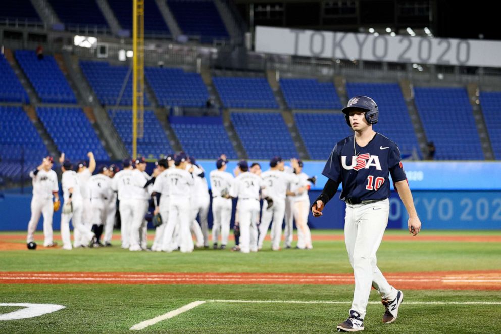 PHOTO: Infielder Nick Allen #10 of Team United States walks off while players of Team Japan celebrate the gold following the gold medal game in the Tokyo 2020 Olympic Games on Aug. 7, 2021, in Yokohama, Japan.