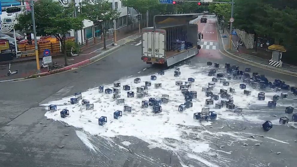 PHOTO: Bottles of beer fall off a truck as the driver makes a sharp turn in Chuncheon, South Korea, June 29, 2022.
