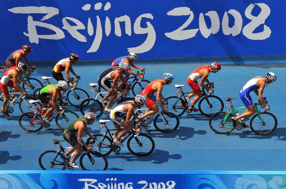 PHOTO: The pack cycle past a Beijing 2008 Olympic logo in the men's triathlon competition at the Beijing 2008 Olympic Games, Aug. 19, 2008.