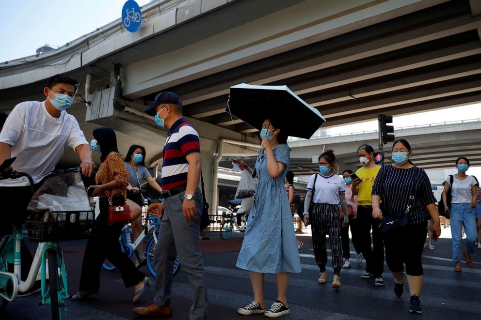 PHOTO: People wear protective masks as they head to work during morning rush hour in Beijing, China, June 15, 2020.
