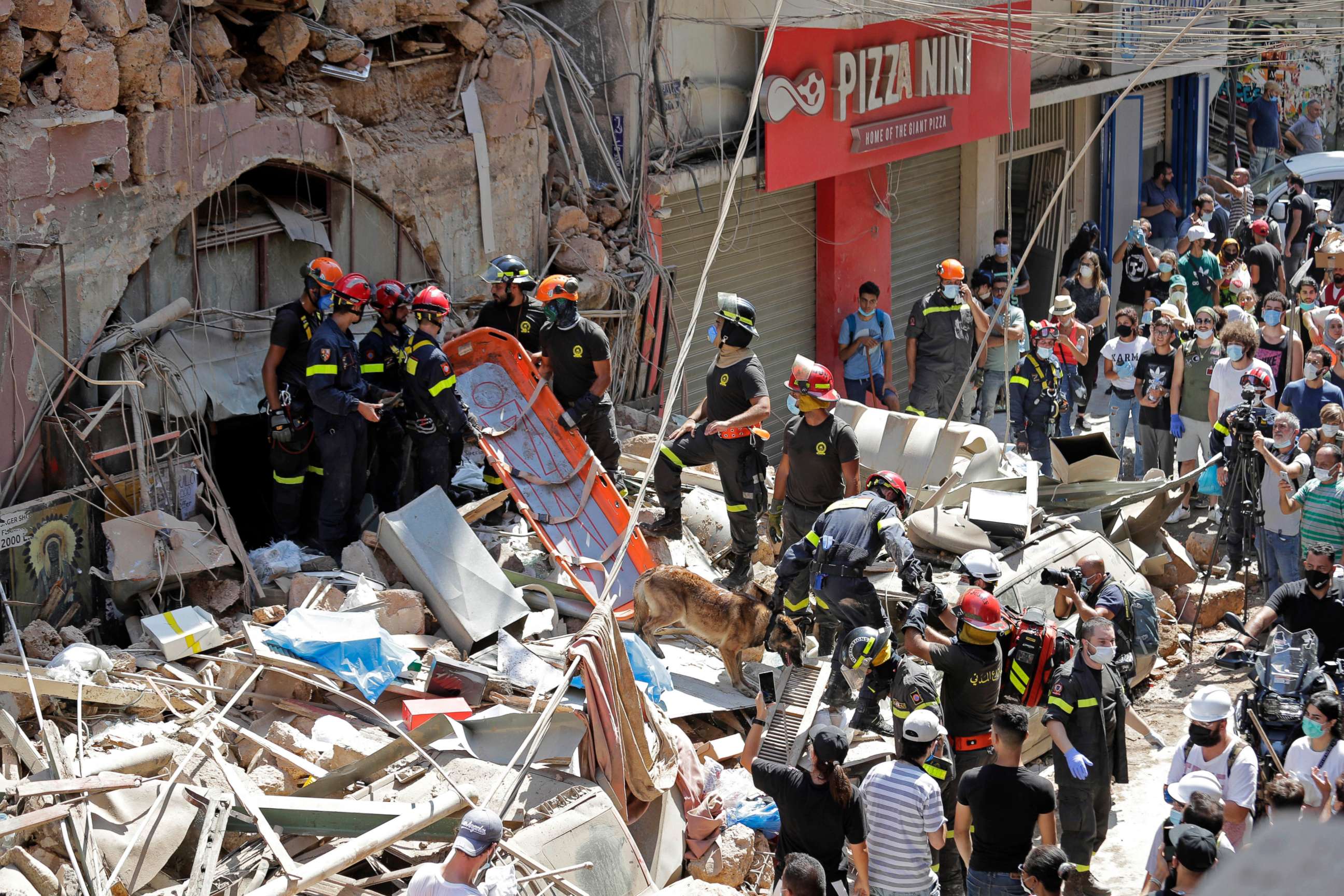 PHOTO: French and Lebanese firemen search in the rubble of a building after the Tuesday explosion at the seaport of Beirut, in Beirut, Lebanon, Aug. 6, 2020.