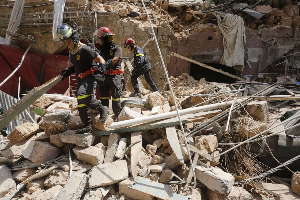 PHOTO: Emergency workers search a collapsed building on August 6, 2020 in Beirut, Lebanon.