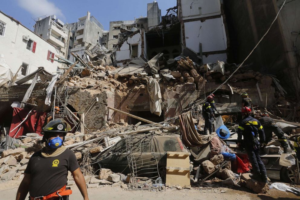 PHOTO: Emergency workers search a collapsed building on August 6, 2020 in Beirut, Lebanon.