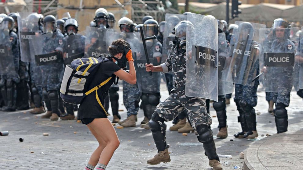 PHOTO: A policeman hits a demonstrator during clashes in downtown Beirut on Aug. 8, 2020.