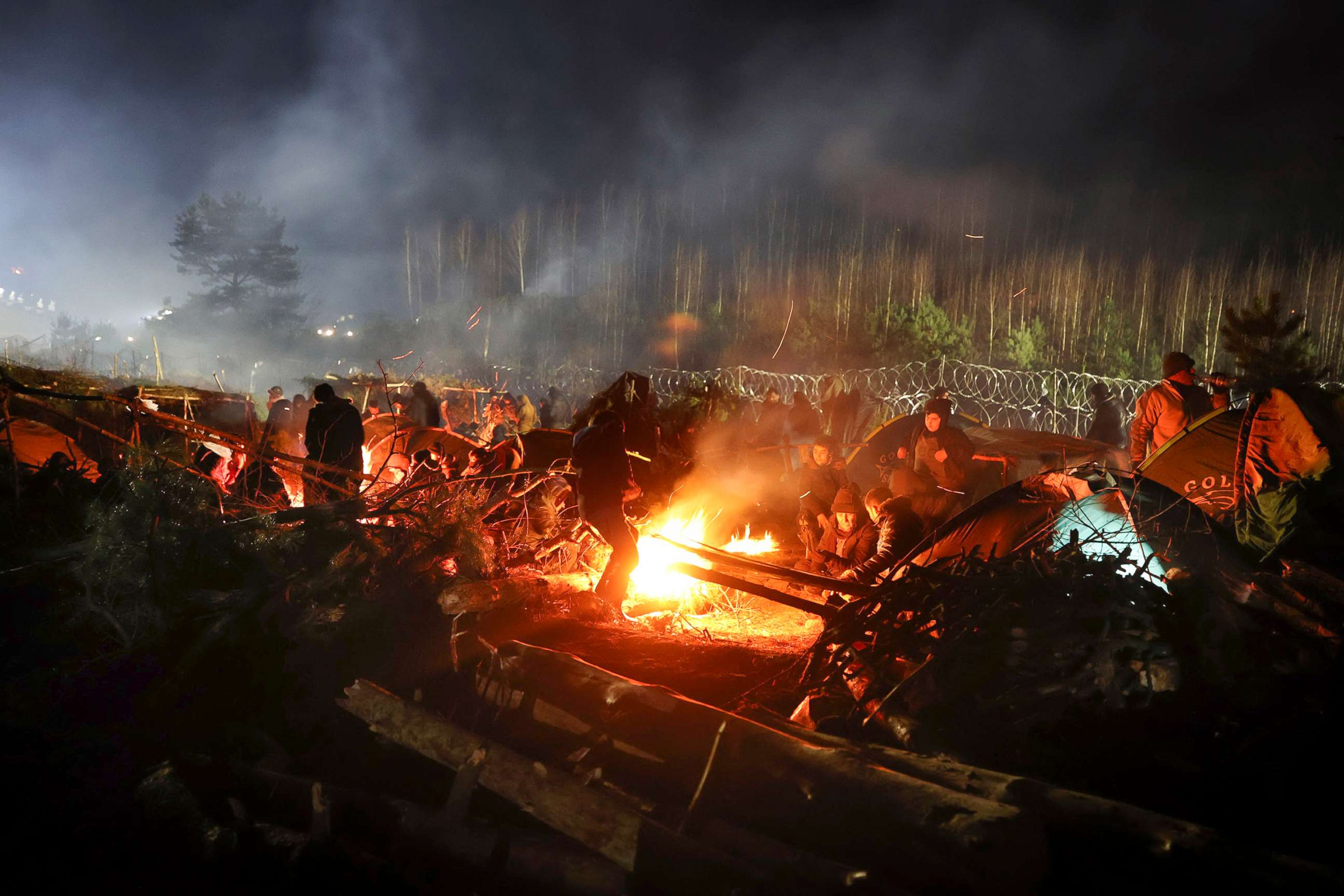 PHOTO: Migrants warm themselves at a fire in frigid conditions as they gather at the Belarus-Poland border near Grodno, Belarus, Nov. 13, 2021.