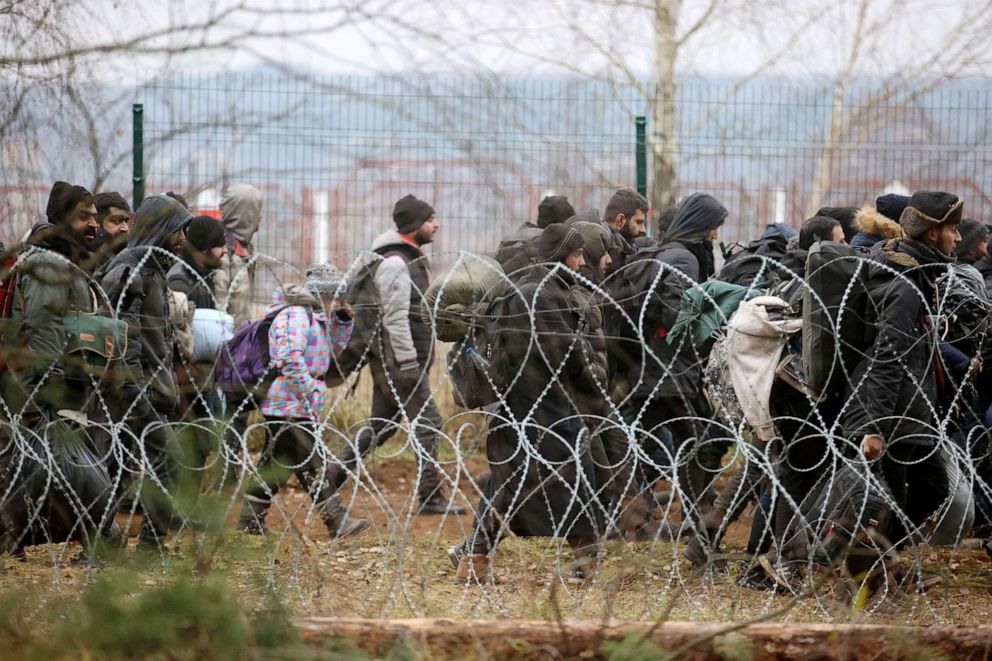 PHOTO: Migrants walk towards the Bruzgi-Kuznica Bialostocka border crossing in an attempt to cross the Belarusian-Polish border in the Grodno Region, Belarus, Nov. 15, 2021.