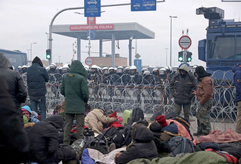 PHOTO: Migrants gather on the Belarusian-Polish border in an attempt to cross it, while Polish police stand guard on the Polish side of the border at the Bruzgi-Kuznica Bialostocka border crossing in the Grodno Region, Belarus Nov. 15, 2021. 