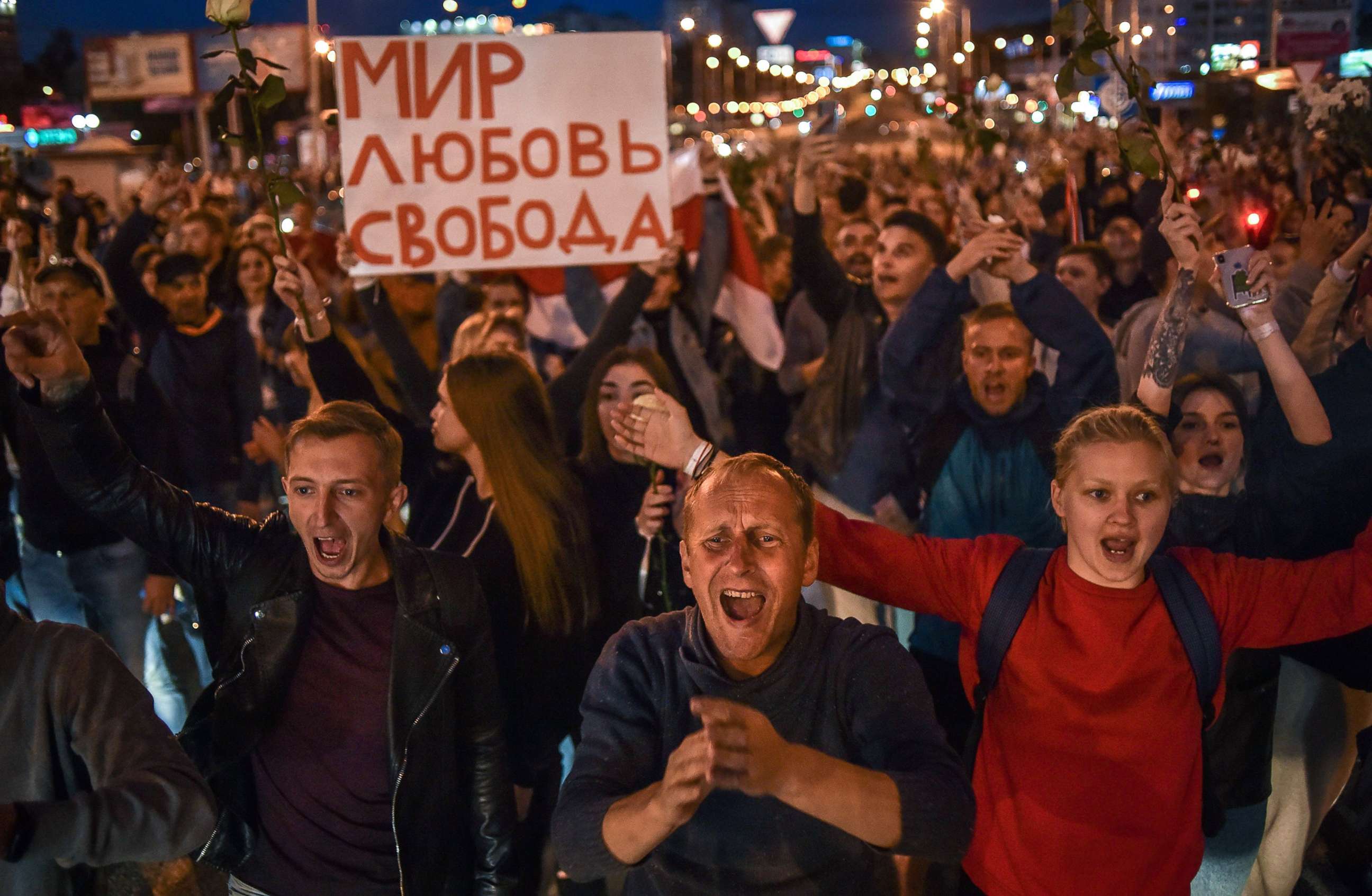 PHOTO: People shout and hold signs protesting against police violence during rallies in opposition to President Alexander Lukashenko's re-election in Minsk, Belarus, Aug. 13, 2020.