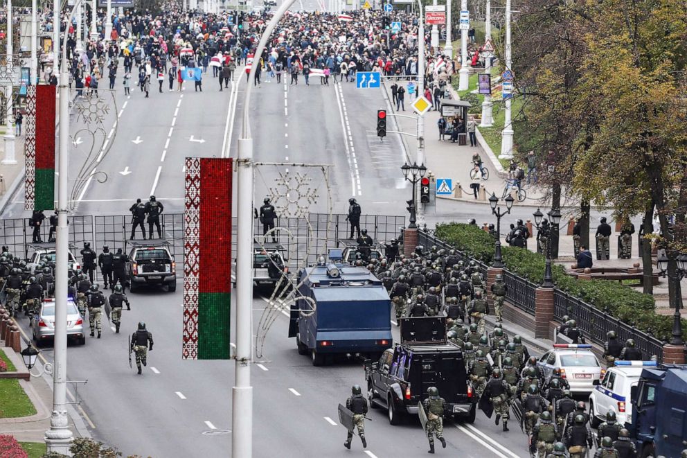 PHOTO: Law enforcement officers block a road as opposition supporters gather in Minsk, on Oct. 25, 2020.