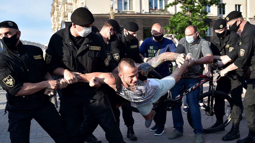 PHOTO: Riot police officers detain an opposition supporter during a gathering to support candidates seeking to challenge President Alexander Lukashenko in August's polls, in Minsk, on June 19, 2020.