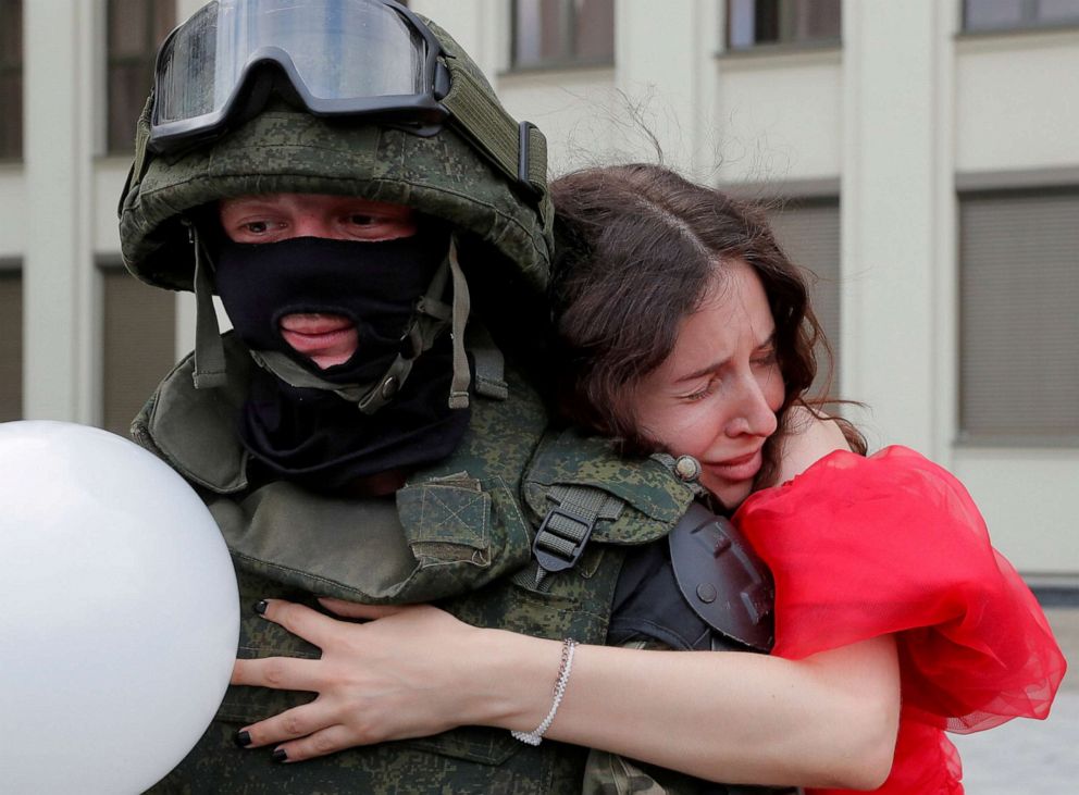 PHOTO: A participant embraces a member of Belarusian Interior Ministry troops during an opposition demonstration in Minsk, Belarus, Aug. 14, 2020.
