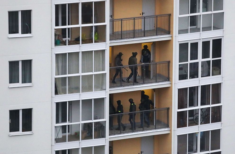 PHOTO: Belarusian policemen look for journalists and protesters in a private apartment building, during a rally against government and President Lukashenko in Minsk, Belarus, Nov. 15, 2020.