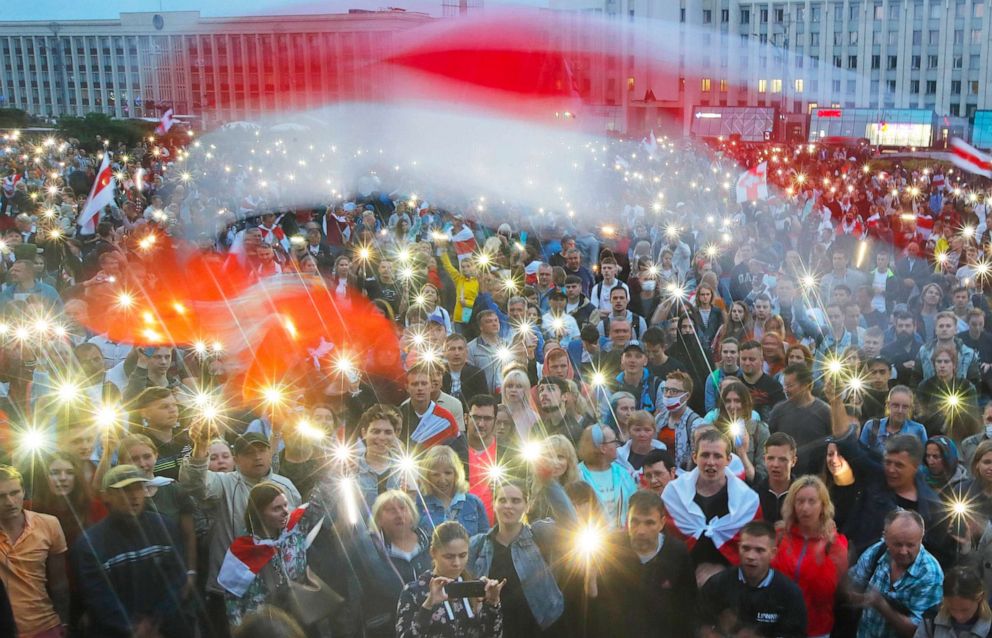PHOTO: Opposition supporters light phones and wave an old Belarusian national flag during a protest rally in Independent Square in Minsk, Belarus, Aug. 19, 2020. 