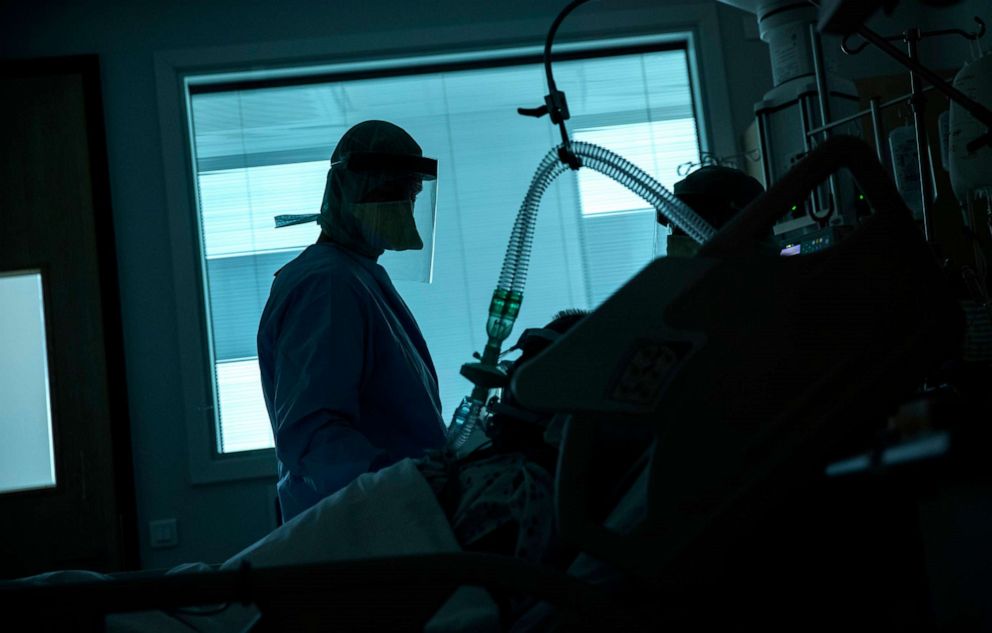 PHOTO: In this file photo taken on March 27, 2020, a health worker in the intensive care ward observes a COVID-19 patient at a hospital in Liege, Belgium.