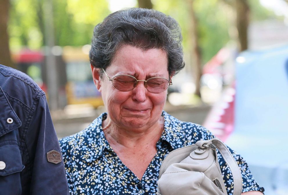 PHOTO: Mother of the police officer Soraya who was shot during the attack, Bernadette Hennart reacts as she pays tribute to her daughter in front of the Cafe 'Les Augustins, in Liege, Belgium, May 30, 2018.