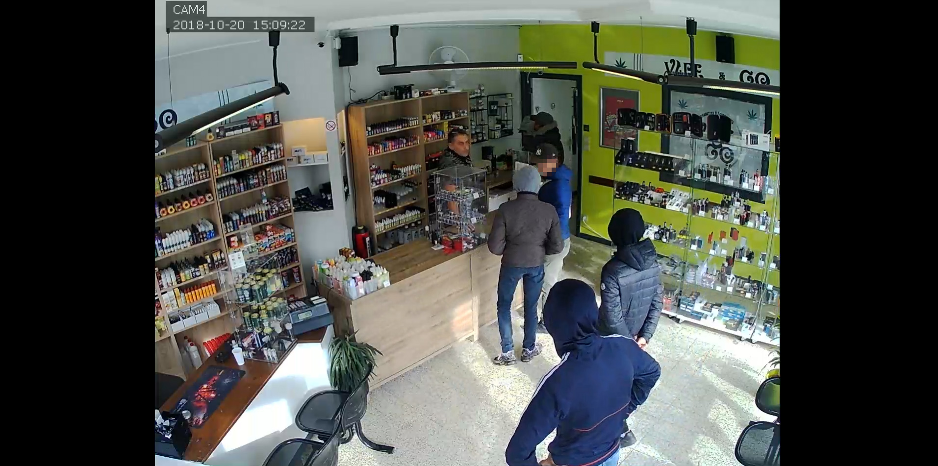 PHOTO: A group of six men are pictured talking to the owner of an e-cigarette store in Montignies-sur-Sambre, Belgium, Oct. 20, 2018. Police say the men attempted to rob the store, but were asked to come back later by the owner.