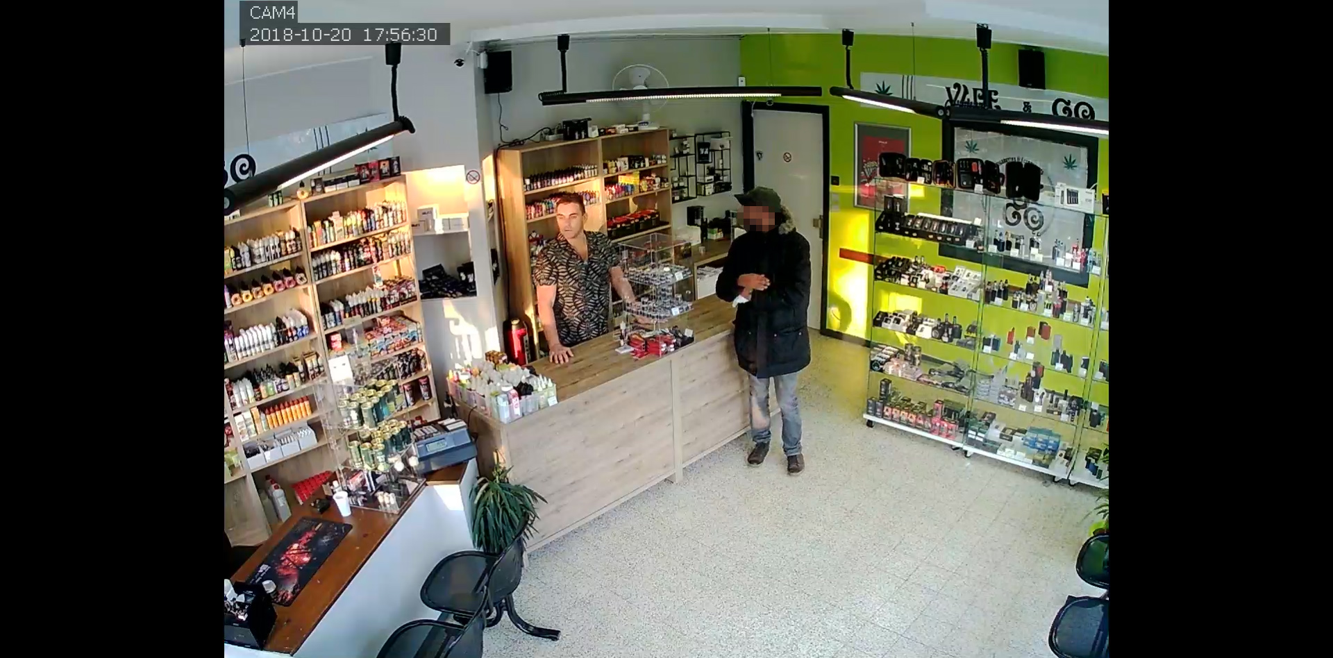 PHOTO: A man from a group that attempted to rob an e-cigarette store in Montignies-sur-Sambre, Belgium, speaks to the owner of the store after returning to the store later in the day, Oct. 20, 2018.