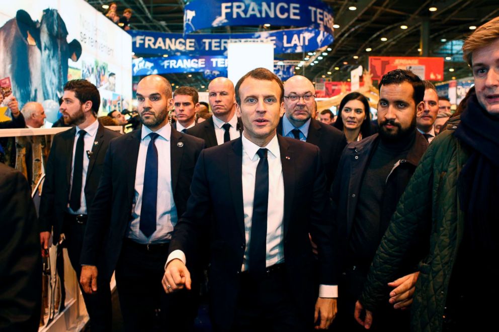 PHOTO: French President Emmanuel Macron (C), flanked by security officer Alexandre Benalla (2ndR), visits the 55th International Agriculture Fair (Salon de l'Agriculture) at the Porte de Versailles exhibition center in Paris, Feb. 24, 2018.
