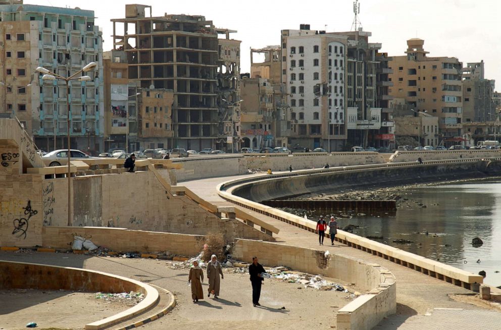 PHOTO: Libyans walk along the seaside promenade in the eastern Libyan port city of Benghazi on Jan. 21, 2020.