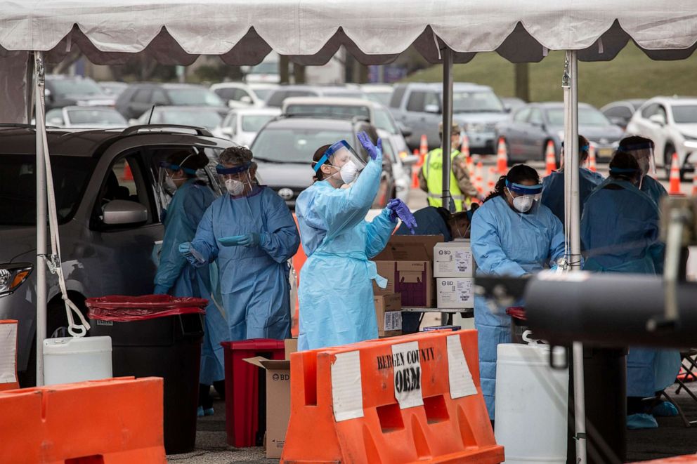 PHOTO: Medical workers at the drive-through coronavirus testing site at Bergen County Community College, March 20 2020, in Paramus, N.J.