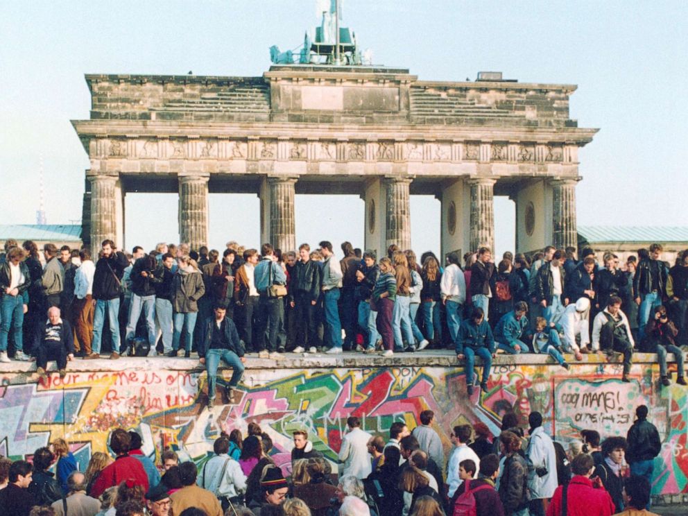PHOTO: In this Nov. 10, 1989, file photo, Germans from East and West stand on the Berlin Wall in front of the Brandenburg Gate in Berlin.