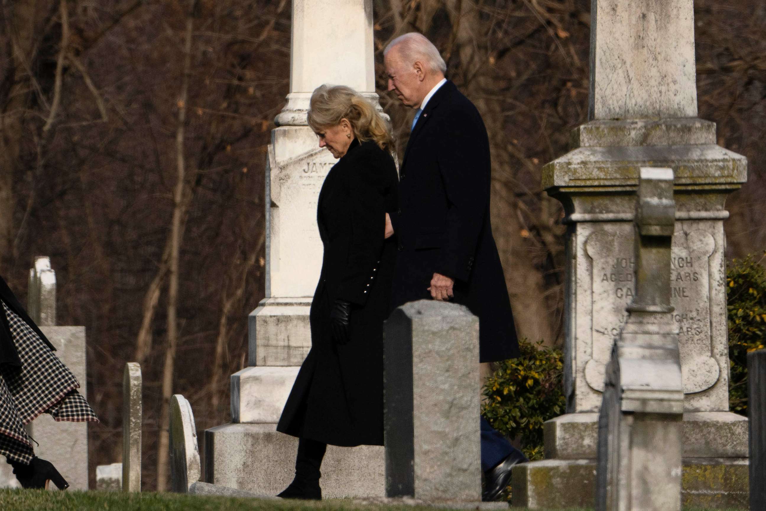 PHOTO: President Joe Biden and first lady Jill Biden walk between tombstones to attend Mass at St. Joseph on the Brandywine Catholic Church in Wilmington, De., Dec. 18, 2022.