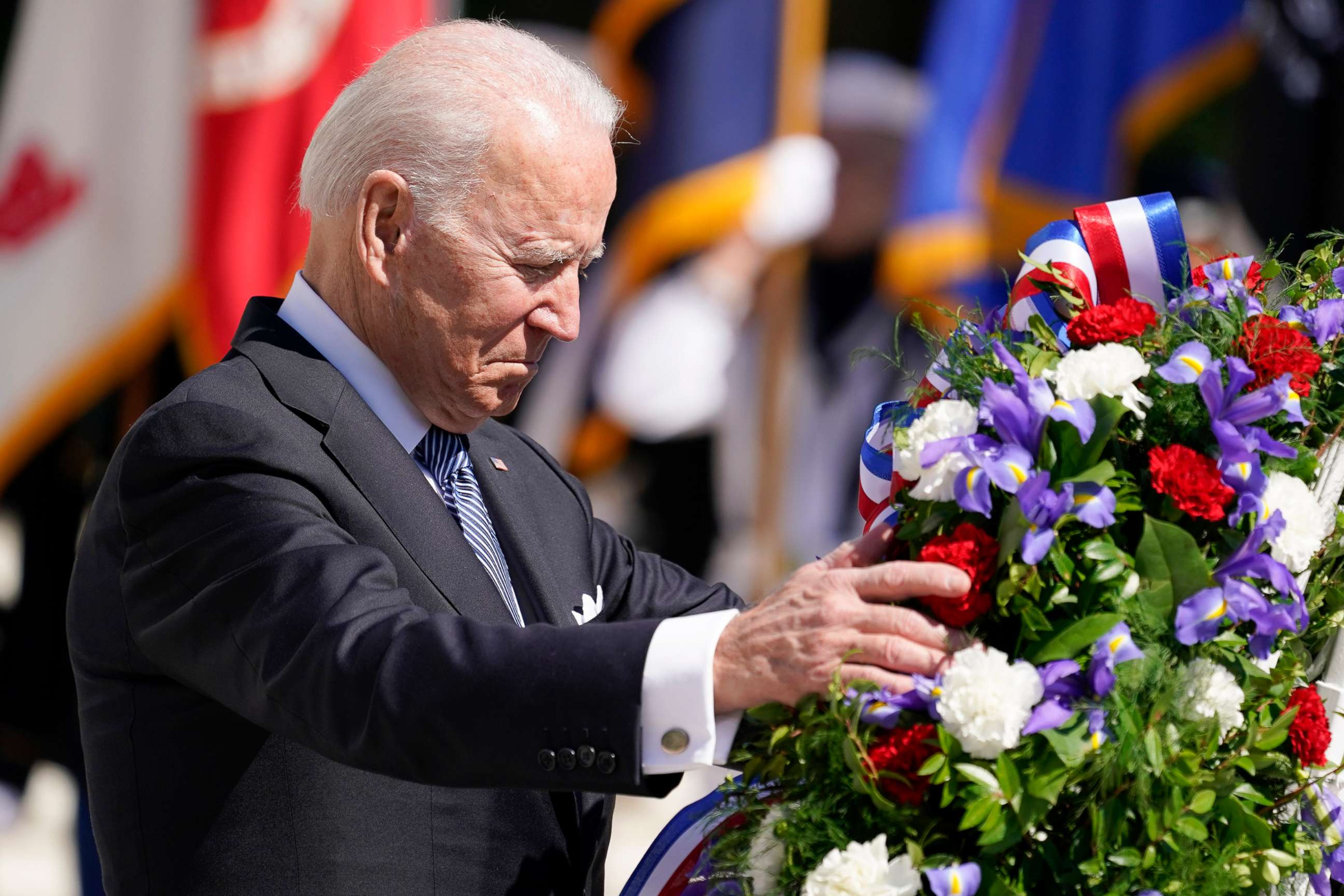 PHOTO: President Joe Biden touches a the wreath at the Tomb of the Unknown Soldier at Arlington National Cemetery on Memorial Day, Monday, May 31, 2021, in Arlington, Va.