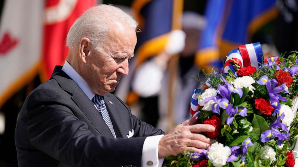 PHOTO: President Joe Biden touches a the wreath at the Tomb of the Unknown Soldier at Arlington National Cemetery on Memorial Day, Monday, May 31, 2021, in Arlington, Va.