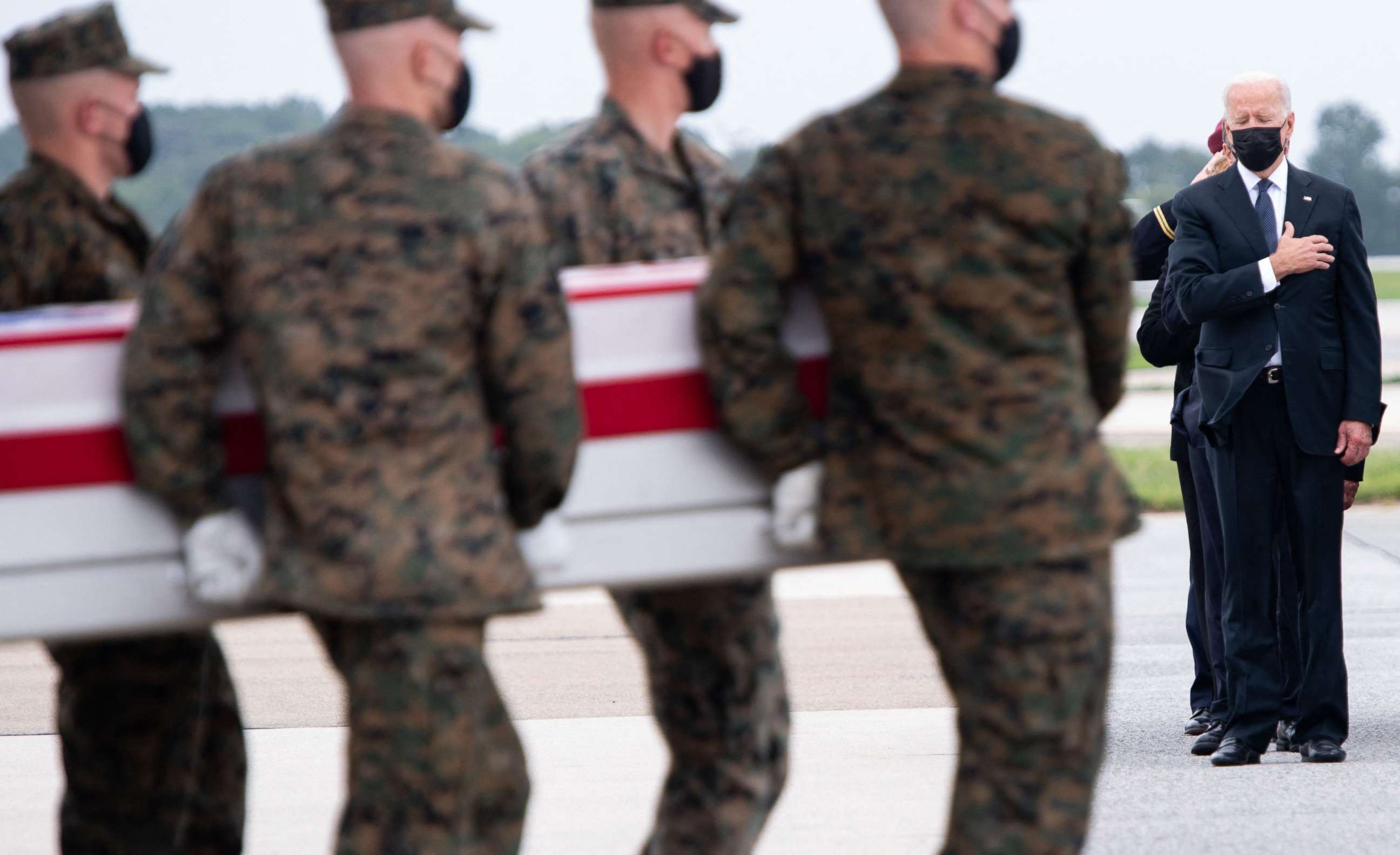 PHOTO: President Joe Biden, right, attends the dignified transfer of the remains of a fallen service members at Dover Air Force Base, Aug. 29, 2021, in Dover, Delaware.