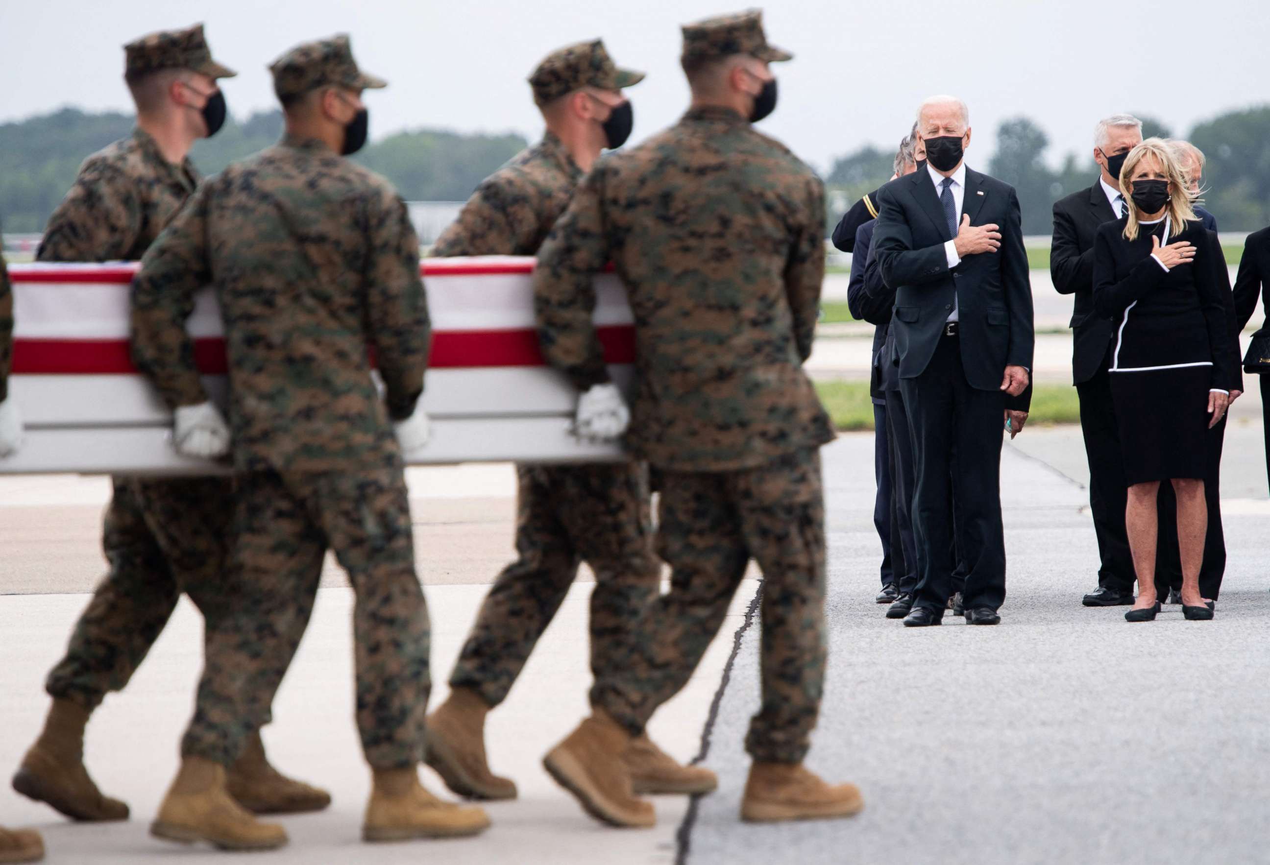 PHOTO: President Joe Biden, center, attends the dignified transfer of the remains of a fallen service members at Dover Air Force Base, Aug. 29, 2021, in Dover, Delaware.