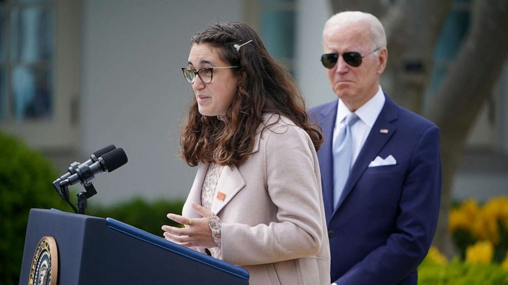 PHOTO: Mia Tretta, a Saugus High School shooting survivor speaks on measures to combat gun crime as US President Joe Biden listens from the Rose Garden of the White House in Washington, April 11, 2022.