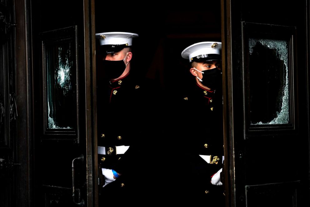 PHOTO: U.S. Marine Corps. hold the damaged Capitol doors during a rehearsal for the 59th inaugural ceremony for President-elect Joe Biden and Vice President-elect Kamala Harris on Jan. 18, 2021 at the U.S. Capitol in Washington.